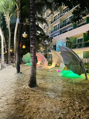 a group of tents on a beach with palm trees at Azure Urban Resort Residences, Condo, Manila Airport, Wave-Pool, Tropical Vibe in Manila