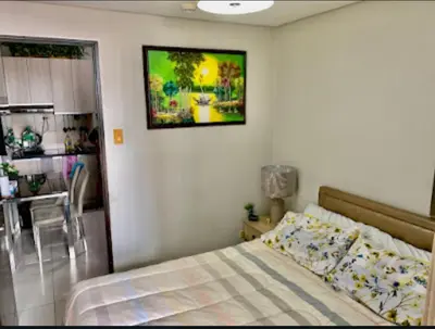 a bedroom with a bed and a picture on the wall at 1BR Near Beach, Airport & In City of Manila Bay in Manila