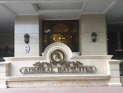 a building with a sign in front of a building at 1BR Near Beach, Airport & In City of Manila Bay in Manila