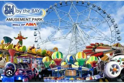 a carnival with a ferris wheel and a amusement park at 1BR Near Beach, Airport & In City of Manila Bay in Manila