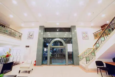 an empty lobby with stairs and a glass door at The Charter House in Manila