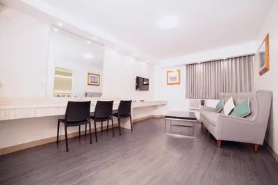 a waiting room with a couch and a table and chairs at The Charter House in Manila