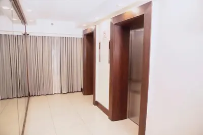 a hallway with doors and curtains in a building at The Charter House in Manila