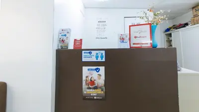 a brown refrigerator with two posters on it at RedDoorz at Kassel Residences Parañaque in Manila