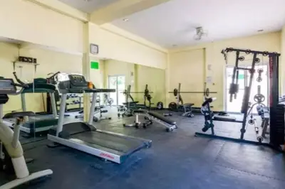 a gym with several treadmills and machines in a room at CHATEAU ELYSEE a3 near airport Wifi Kitchen in Manila