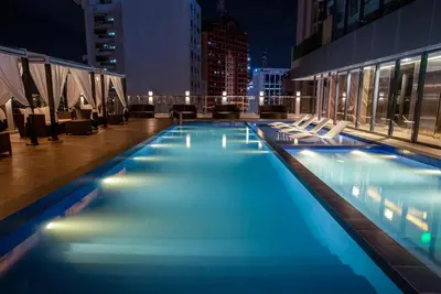 a swimming pool on top of a building at night at Coro Hotel in Manila
