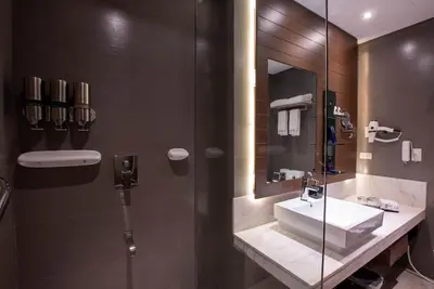 a bathroom with a sink and a mirror at Coro Hotel in Manila