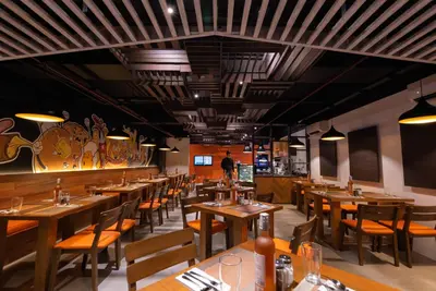 a dining room with wooden tables and chairs at Coro Hotel in Manila