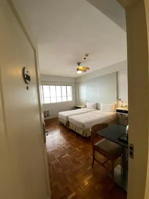 a hotel room with a bed and a table at The Clipper Hotel, Poblacion Makati in Manila