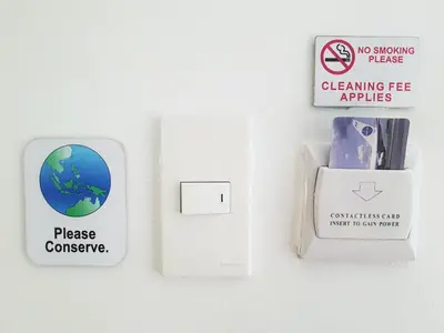 a lightswitch and a sign on a wall at The Clipper Hotel, Poblacion Makati in Manila