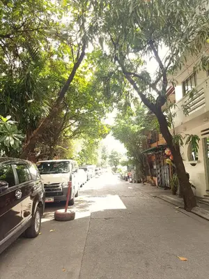 a street with cars parked on the side of the road at The Clipper Hotel, Poblacion Makati in Manila