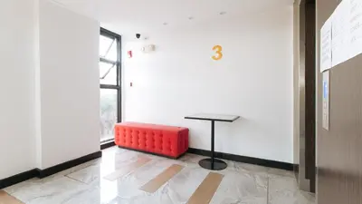 a red bench sitting in a room with a table at RedDoorz Plus at MM Hotel Las Pinas former RedDoorz Plus Near Bamboo Organ in Manila