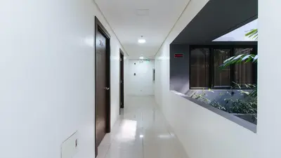 a hallway of a house with a plant on the wall at RedDoorz Plus at Evangelista Street Makati in Manila