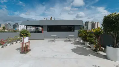 a building with a picnic table on top of it at RedDoorz Plus at Evangelista Street Makati in Manila