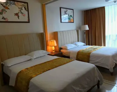 a hotel room with two beds and a window at ONE UPTOWN RESIDENCE in Manila