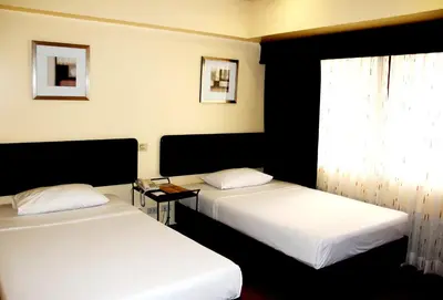 a room with two beds and a window at AIM Conference Center in Manila
