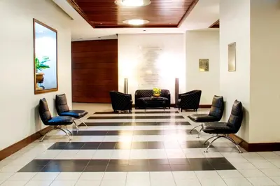 a waiting room in a hospital with chairs and a table at AIM Conference Center in Manila