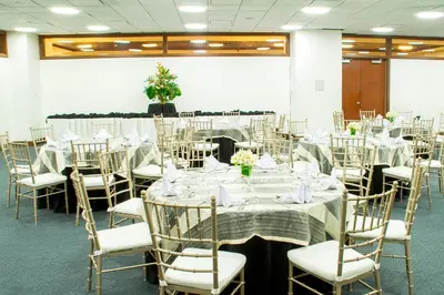 a banquet hall with tables and chairs with white tablecloths at AIM Conference Center in Manila