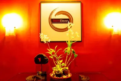 a red wall with two lights and a picture of berk oven at AIM Conference Center in Manila