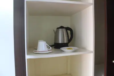 a tea kettle and a bowl on a shelf at AIM Conference Center in Manila