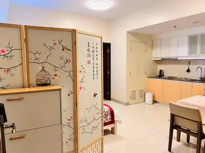 a kitchen with a refrigerator with flowers and birds on it at ONE UPTOWN residence SW14M 9TH AVENUE ST \u516c\u5bd3 in Manila