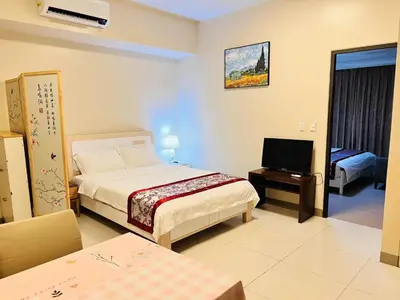 a hotel room with a bed and a television at ONE UPTOWN residence SW14M 9TH AVENUE ST \u516c\u5bd3 in Manila