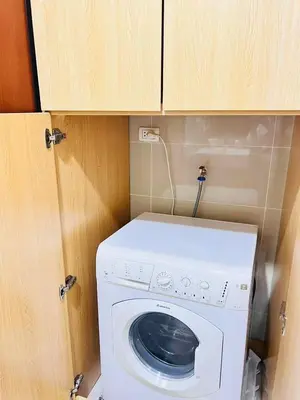 a washer and dryer in a small room at ONE UPTOWN residence SW14M 9TH AVENUE ST \u516c\u5bd3 in Manila
