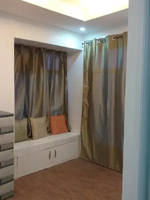 a bedroom with a window seat with curtains at Mia and Miguel's House in General Trias