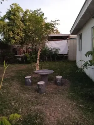 a picnic table in a yard with a tree at Mia and Miguel's House in General Trias