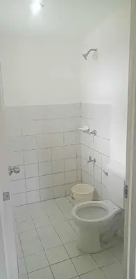 a white bathroom with a toilet and a sink at Mia and Miguel's House in General Trias