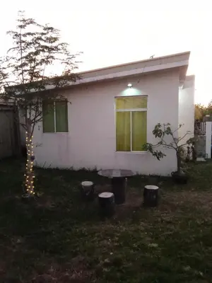 a house with a picnic table in the yard at Mia and Miguel's House in General Trias