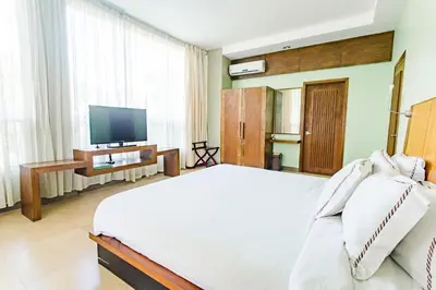a bedroom with a large bed and a television at The Park - Silang in Silang