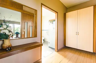 a hallway with a mirror and a door to a bathroom at The Park - Silang in Silang