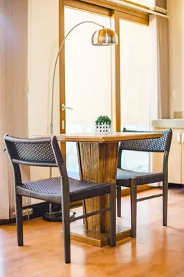 a dining room table with two chairs and a lamp at The Park - Silang in Silang