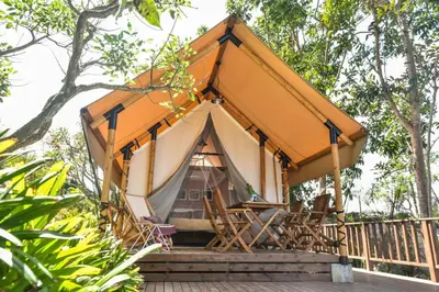 a tent with chairs on a wooden deck at The Park - Silang in Silang
