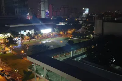 a view of a city at night with a building at MANDALUYONG 2 Br w 2 Queen, 50HDtv across Shangrila Mall in Manila