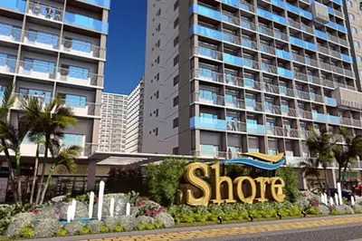 a store sign in front of a large building at Jones Shore Residences in Manila
