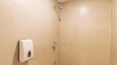 a shower with a soap dispenser in a bathroom at RedDoorz at Ranchotel Alabang in Manila