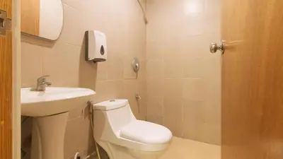a small bathroom with a toilet and a sink at RedDoorz at Ranchotel Alabang in Manila
