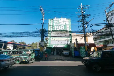a city street with a large building in the background at RedDoorz at Ranchotel Alabang in Manila