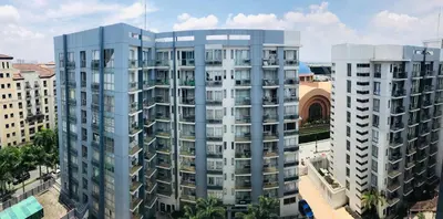 an aerial view of two tall buildings in a city at One Palm Tree Villas across NAIA-T3 in Manila