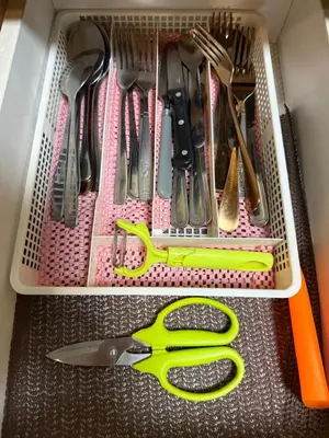 a drawer with a pair of scissors and utensils at One Palm Tree Villas across NAIA-T3 in Manila