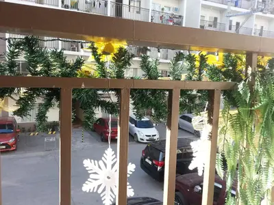 a balcony with a view of a parking lot at Jen's Apartment in Manila