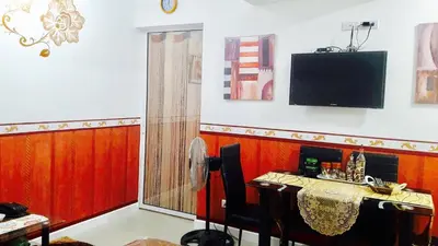 a living room with a table and a television at Azure C3 Balcony Wifi near mall airport in Manila