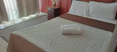 a bed with a white pillow sitting on top of it at Azure C3 Balcony Wifi near mall airport in Manila