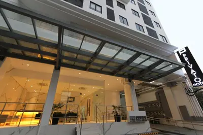 a large building with a large glass facade at Privato Makati in Manila