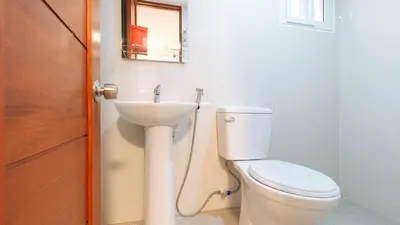 a bathroom with a toilet and a sink at RedDoorz near PNR Espana Station in Manila