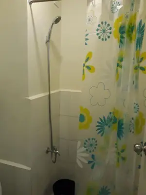 a bathroom with a shower with a shower curtain at Edsa Urban Deca Tower Condo Unit with Wifi and Netflix in Manila