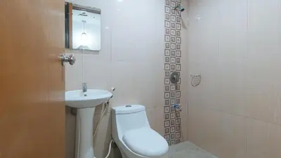 a bathroom with a toilet and a sink at RedDoorz at Ranchotel Bayanan Alabang in Manila