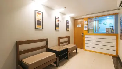 a waiting room with two chairs and a door at RedDoorz at Ranchotel Bayanan Alabang in Manila